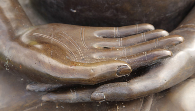 Buddha hands on a statue in Maui